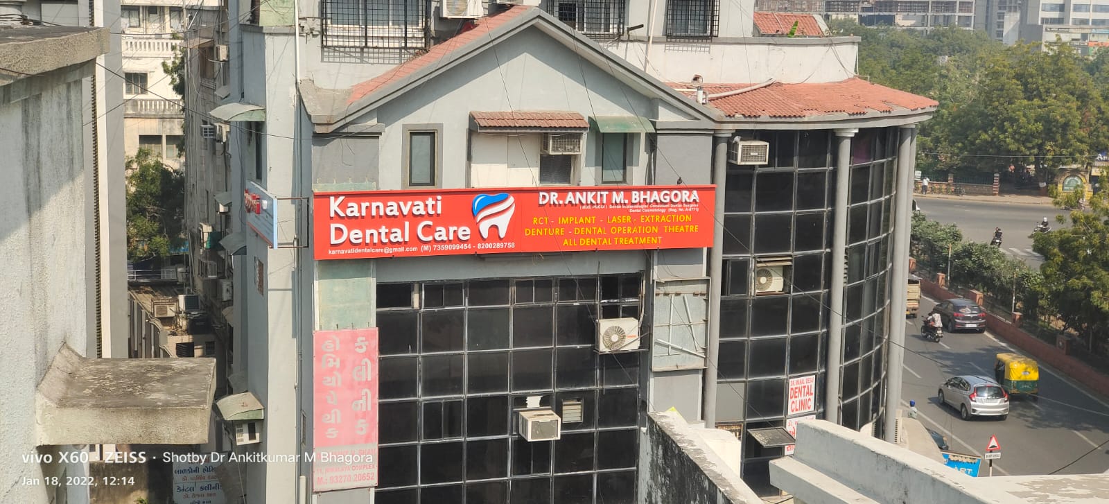 The Karnavati Dental Care signboard on the clinic building at Nehru Park Cross Road, Lad Society Road, Vastrapur, Ahmedabad