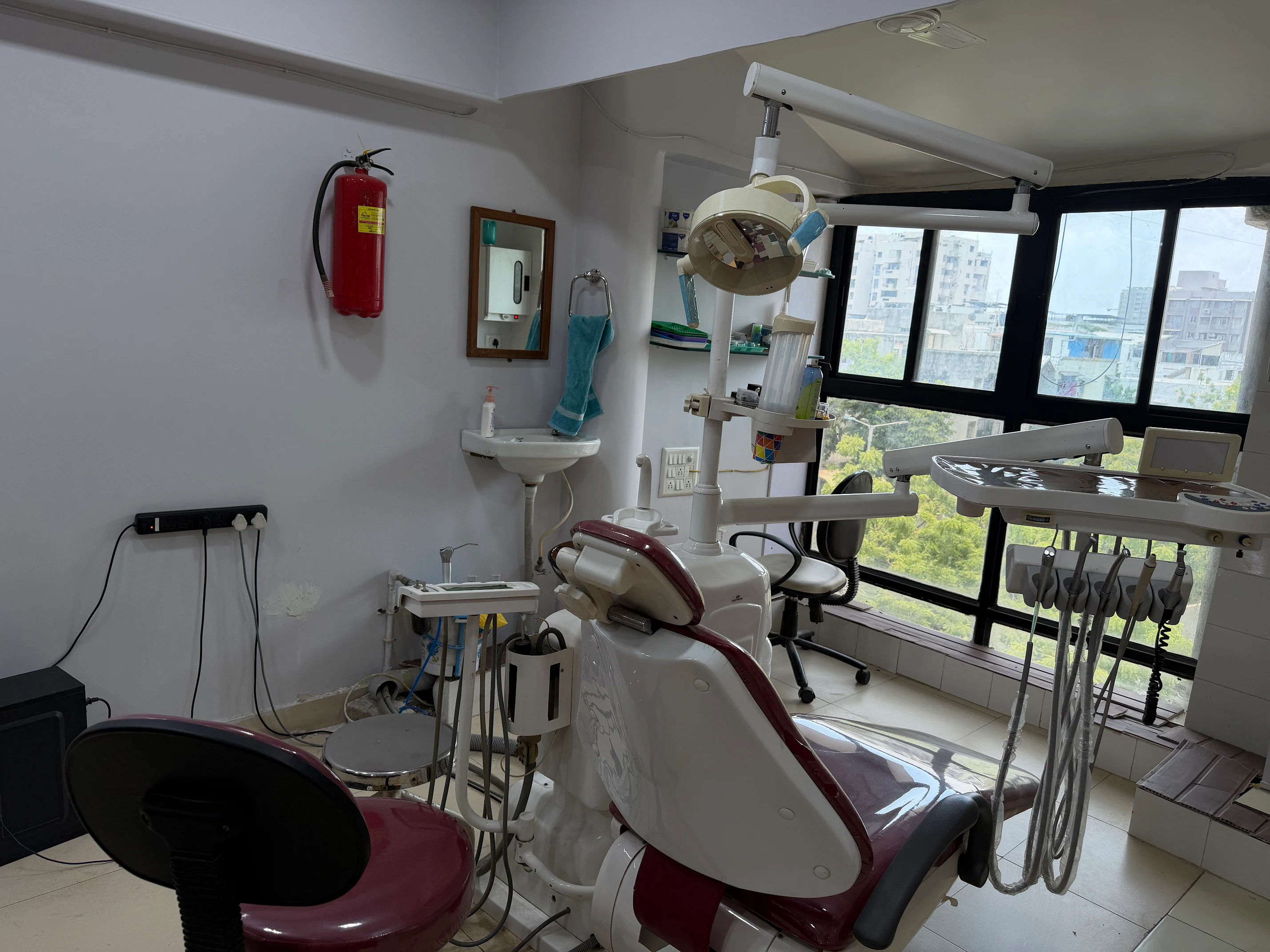 The treatment room at Karnavati Dental Care in Vastrapur, with the dental chair, overhead light and intraoral scanner ready for a patient